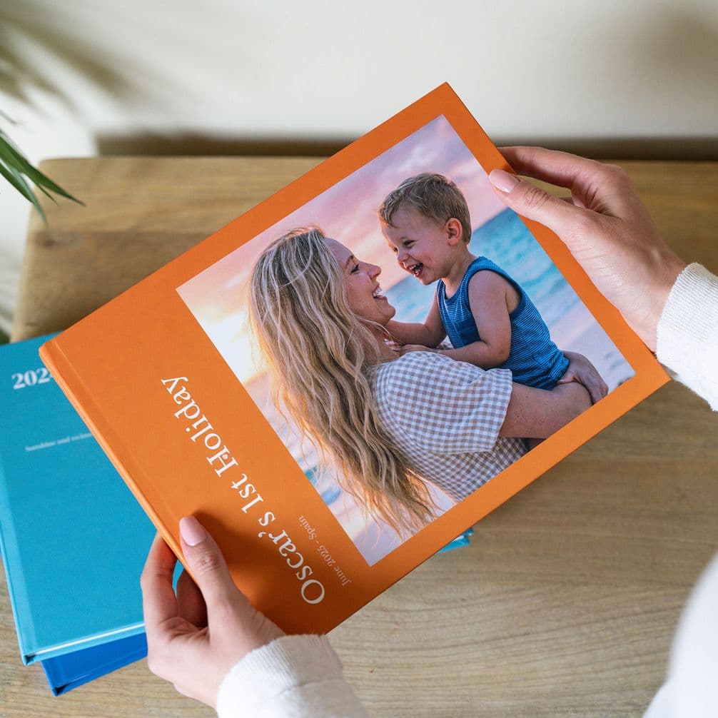 Orange hardcover photo book of baby's first holiday
