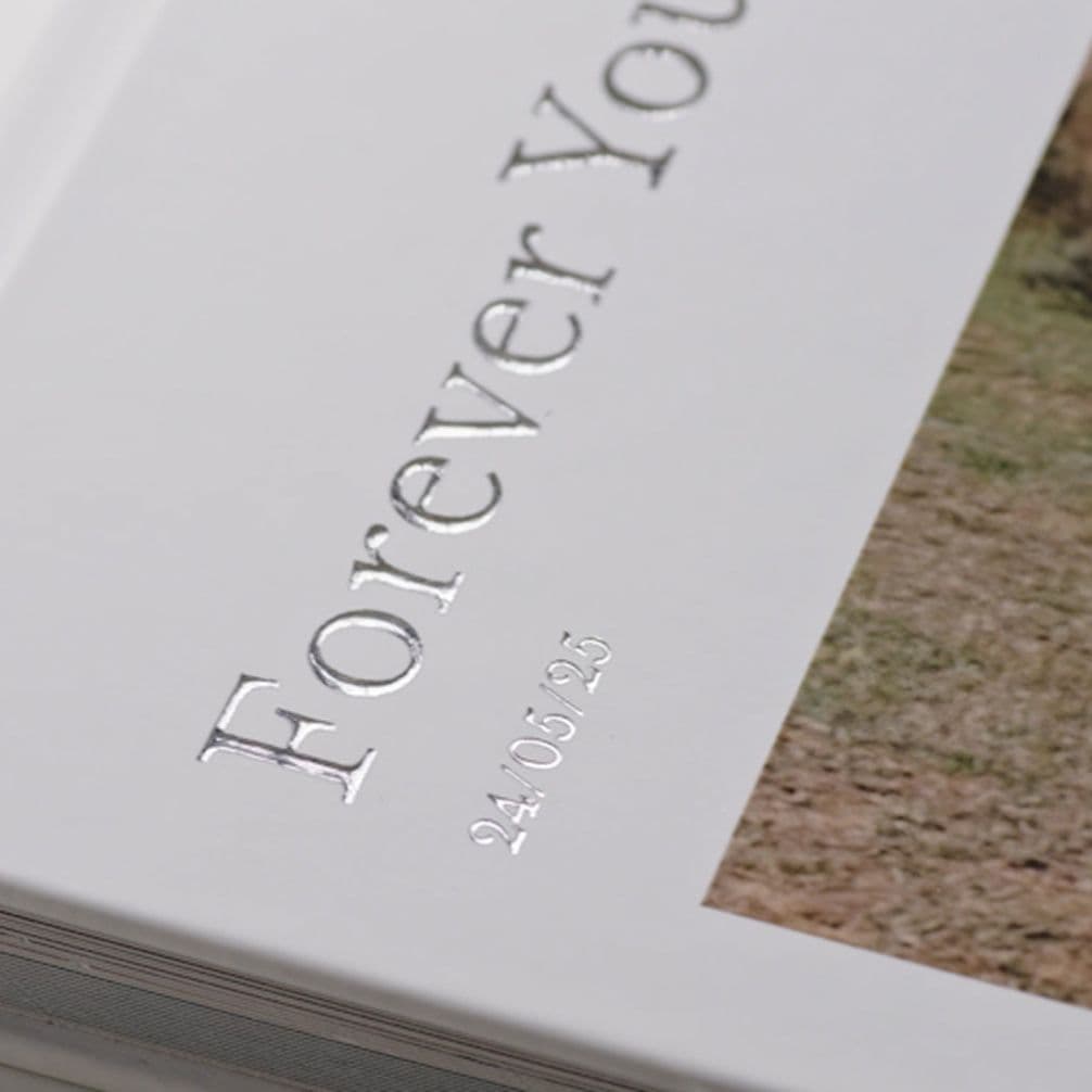 Silver text on cover of wedding photo book