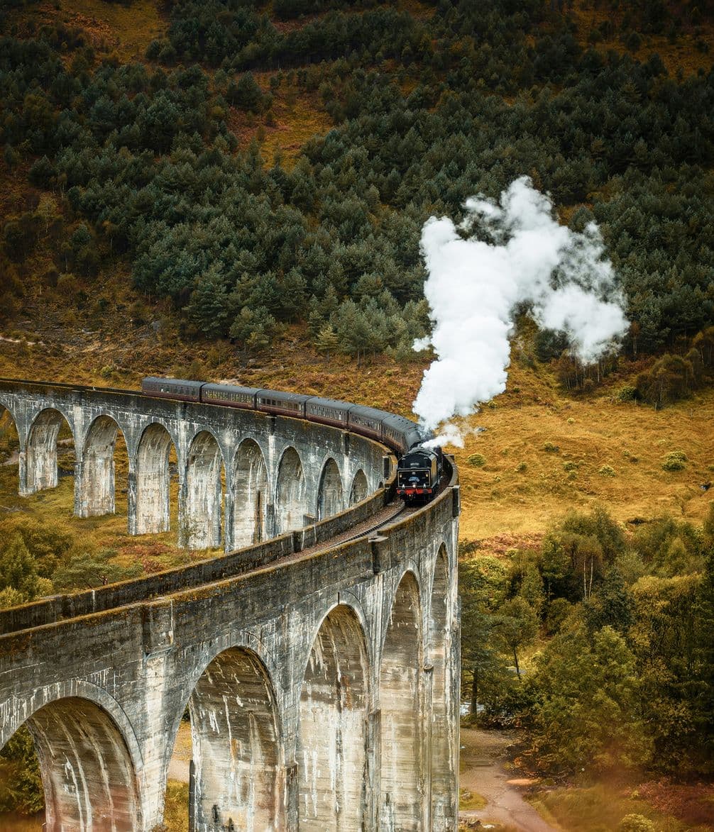 Steam train passing the Glenfinnan Viaduct