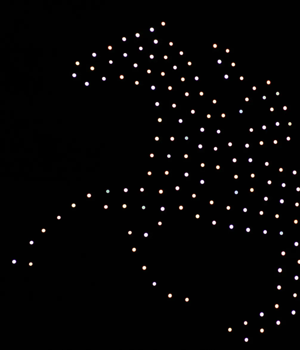 Rows of illuminated, multicolored dots form an outline of a horse against a black background.