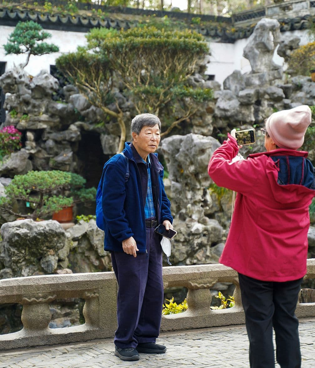 Woman taking a photograph of her husband