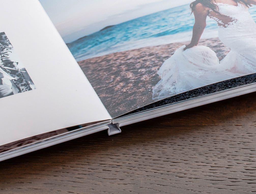 An image of a bride on a beach inside a hardcover photo book