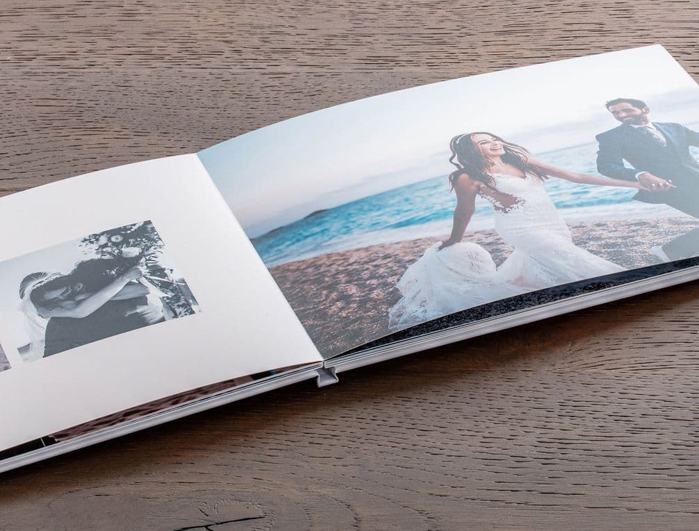 Couple pictured on a beach on their wedding day in a hardcover photo book