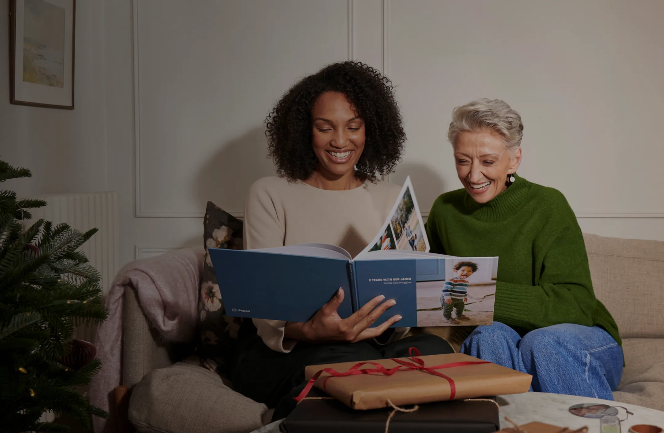Friends looking through a Photo Book at Christmas