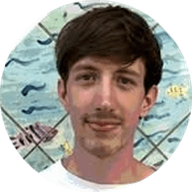 Portrait of a young man with short brown hair and a light mustache, wearing a white shirt, against a mural of fish and blue waves.