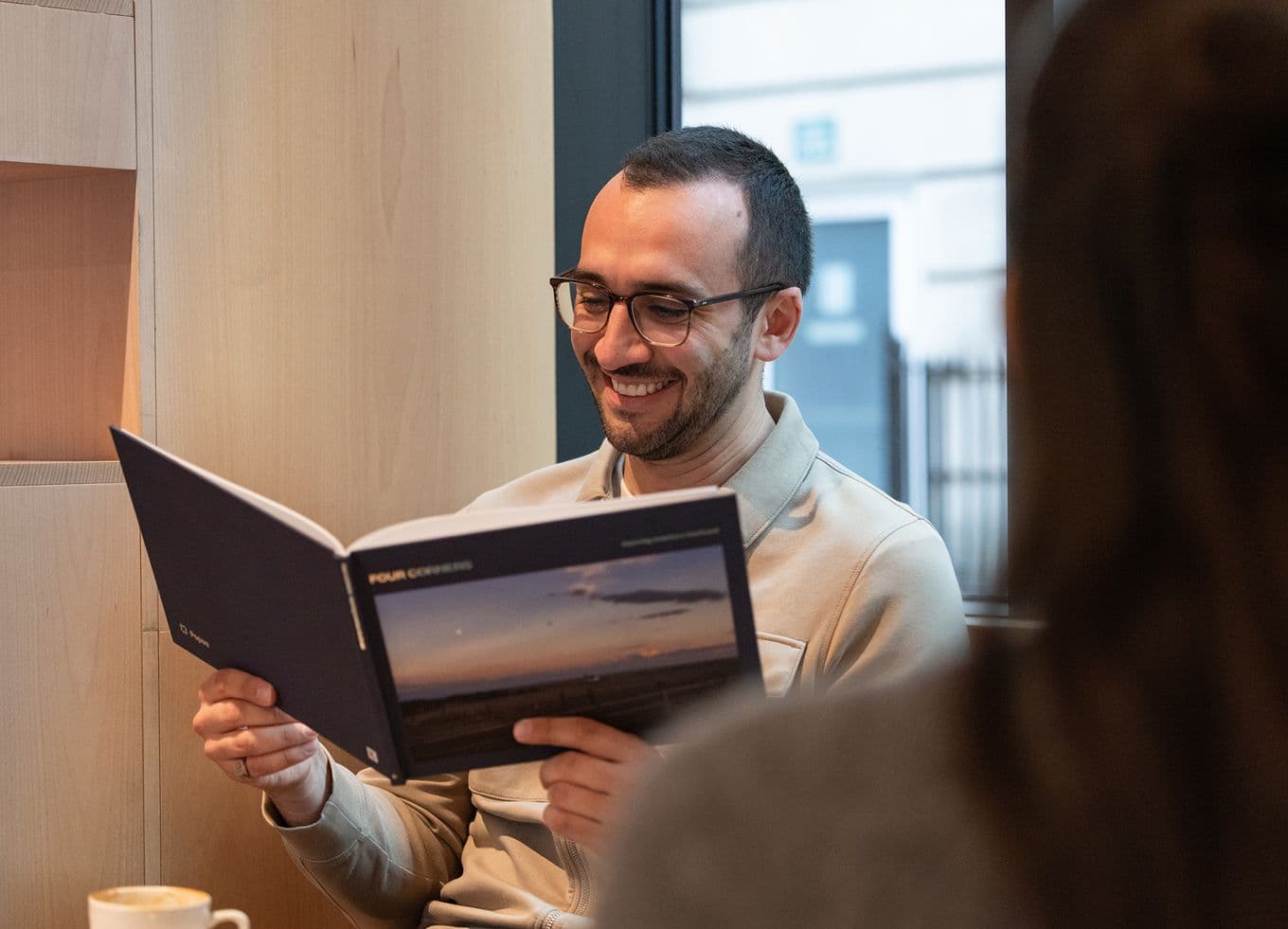 Person smiling looking through a photo book