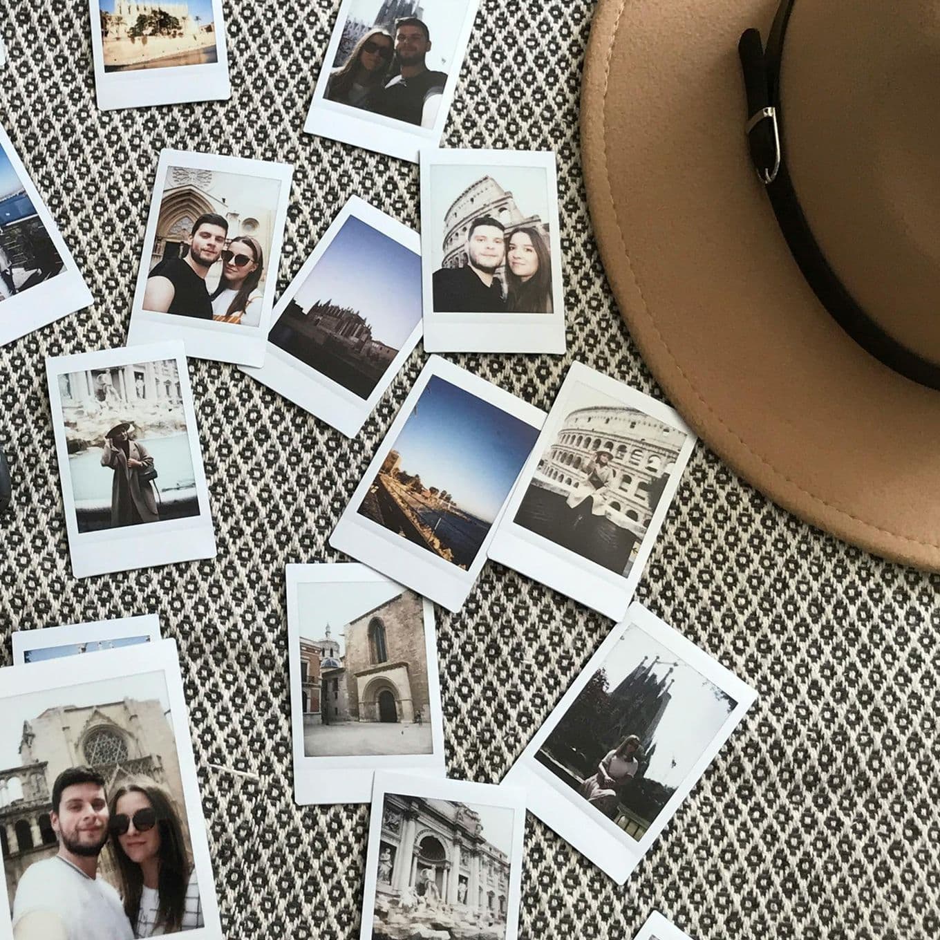 Instant, polaroid-style travel photos spread out on a tablecloth