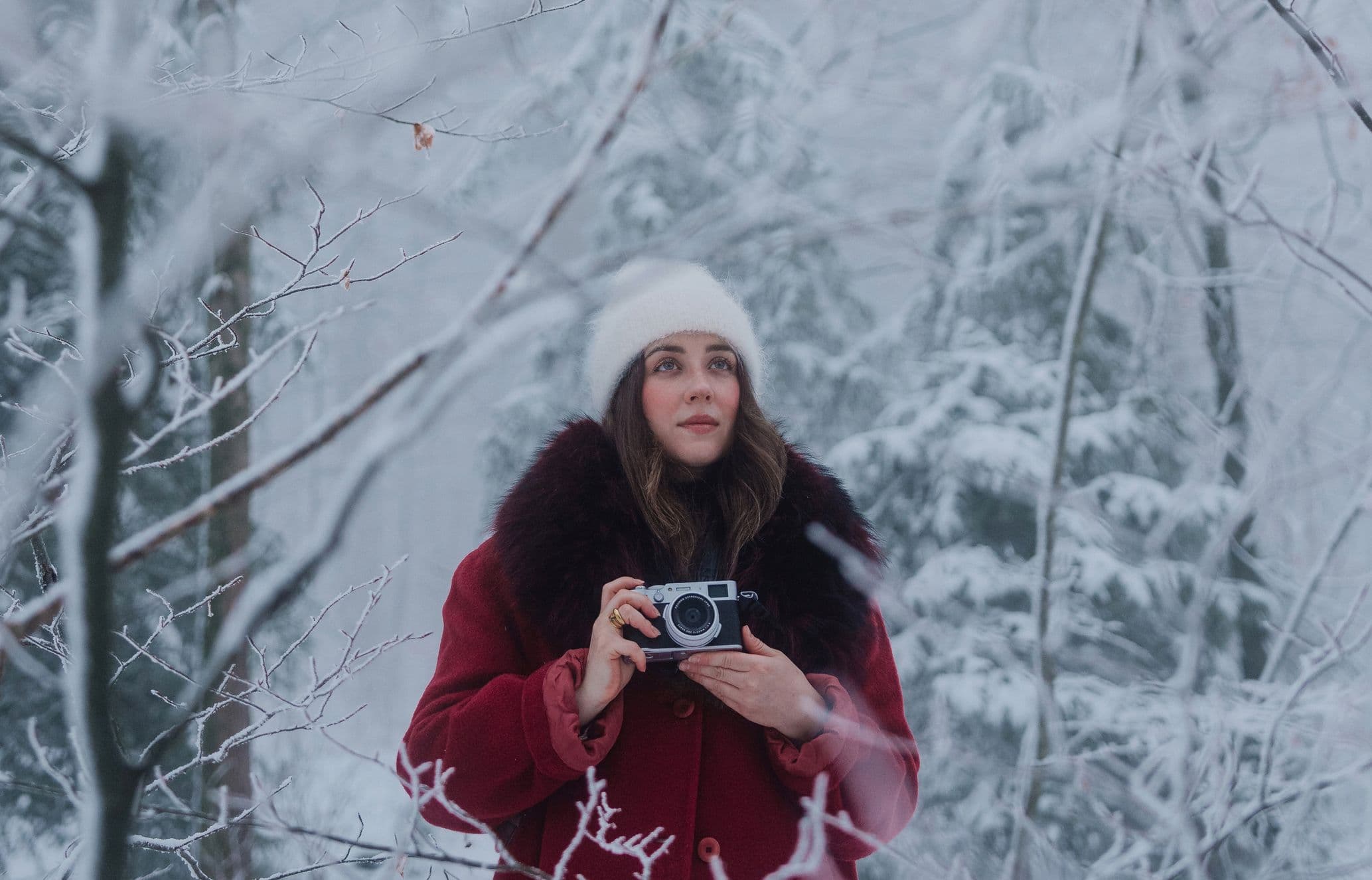Woman with her camera in snowy landscape