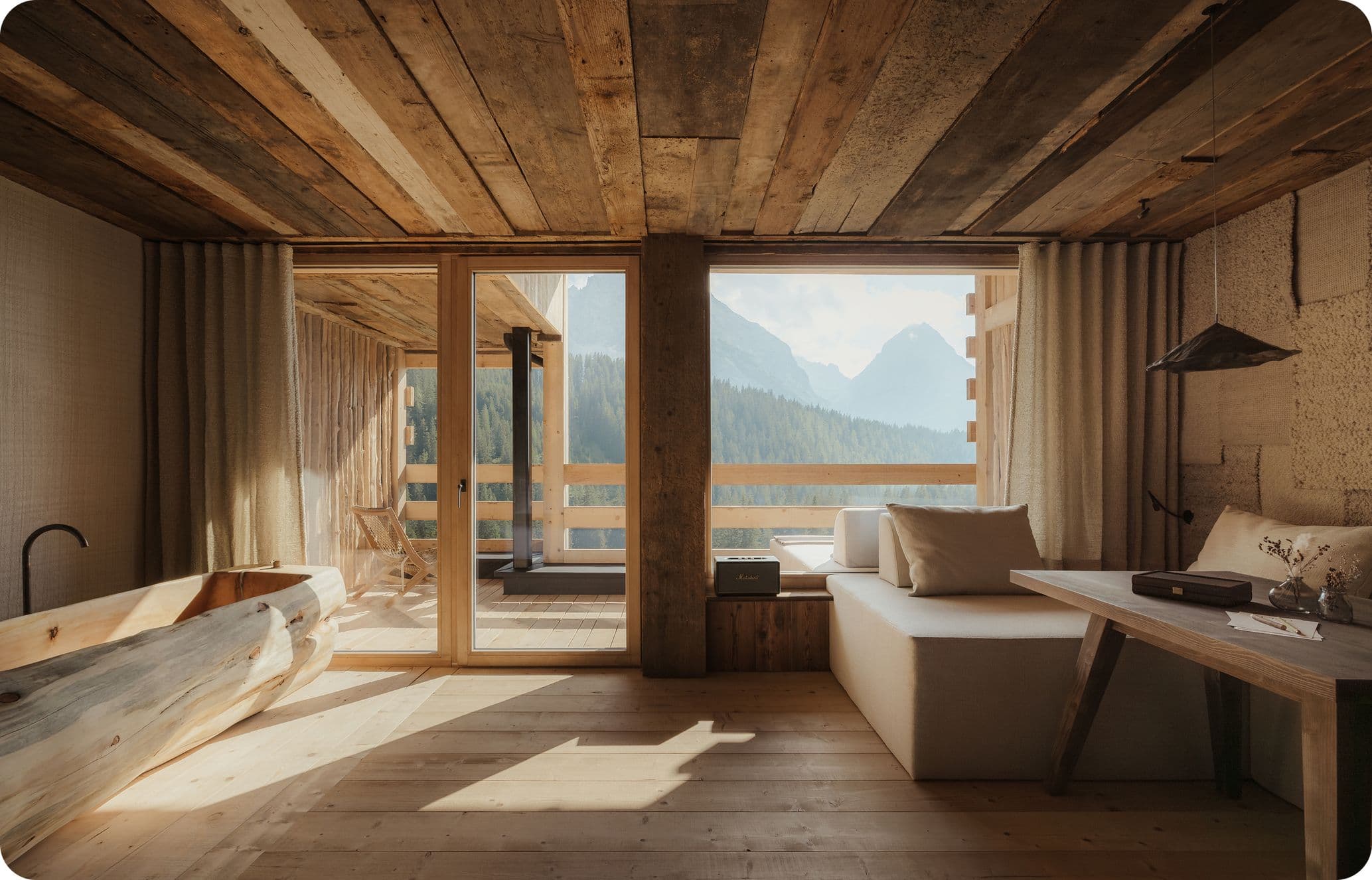 Pared-back wood interiors in a suite with mountain views