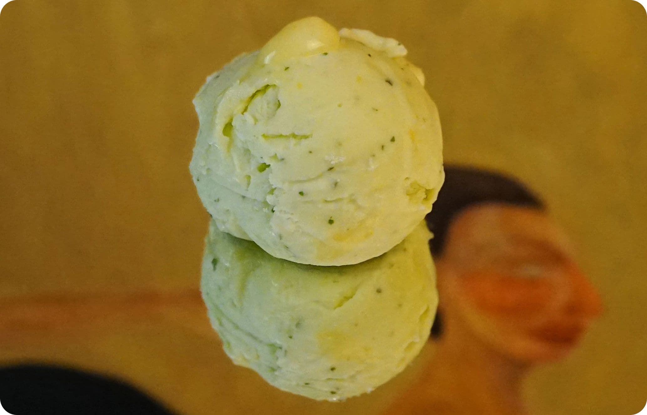 Scoop of basil and lemon curd ice cream