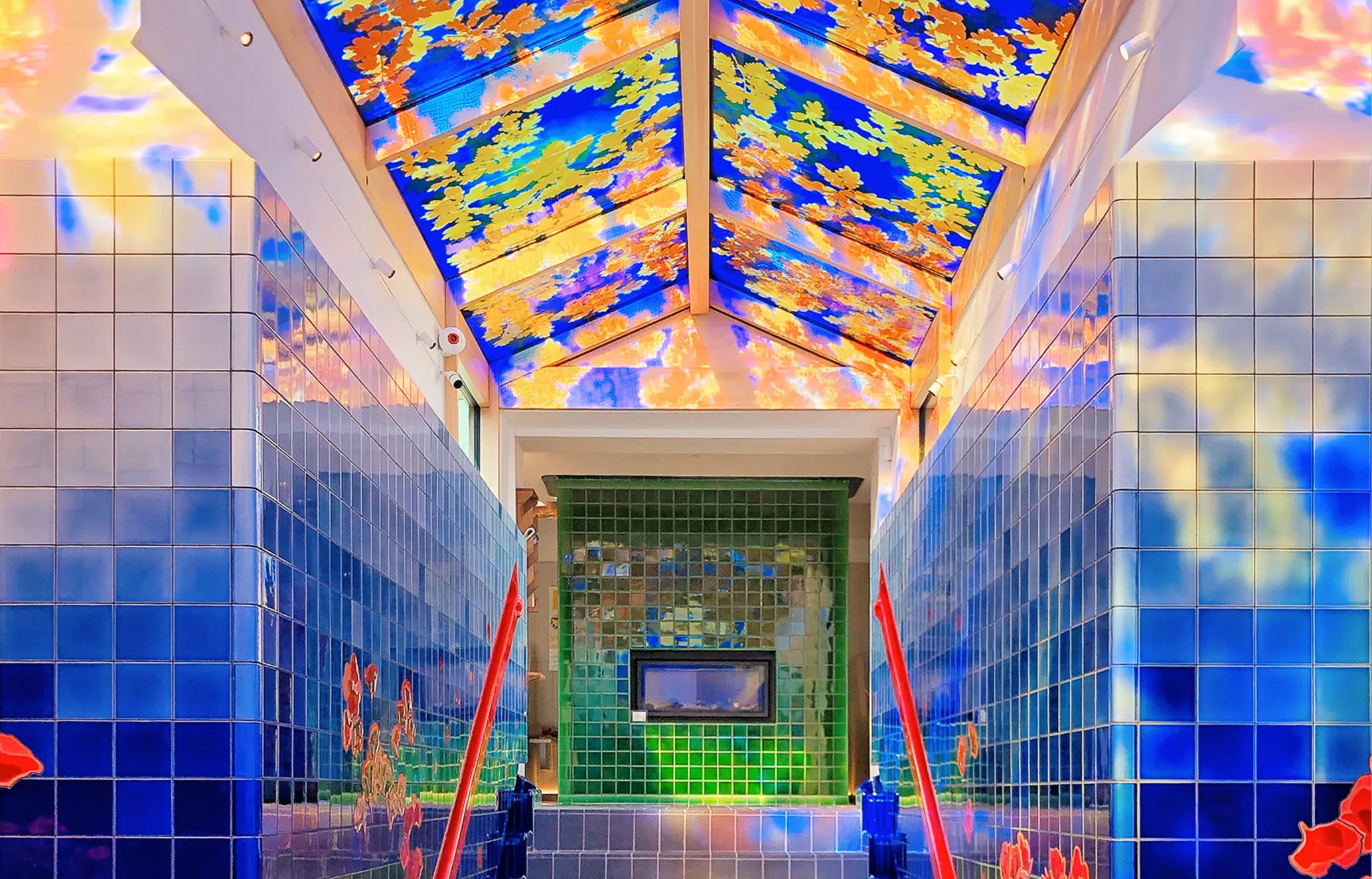 A colorful, tiled hallway with blue walls, a green tiled far wall, and a bright ceiling showing a blue sky with yellow and orange leaves. Red abstract shapes adorn the walls.