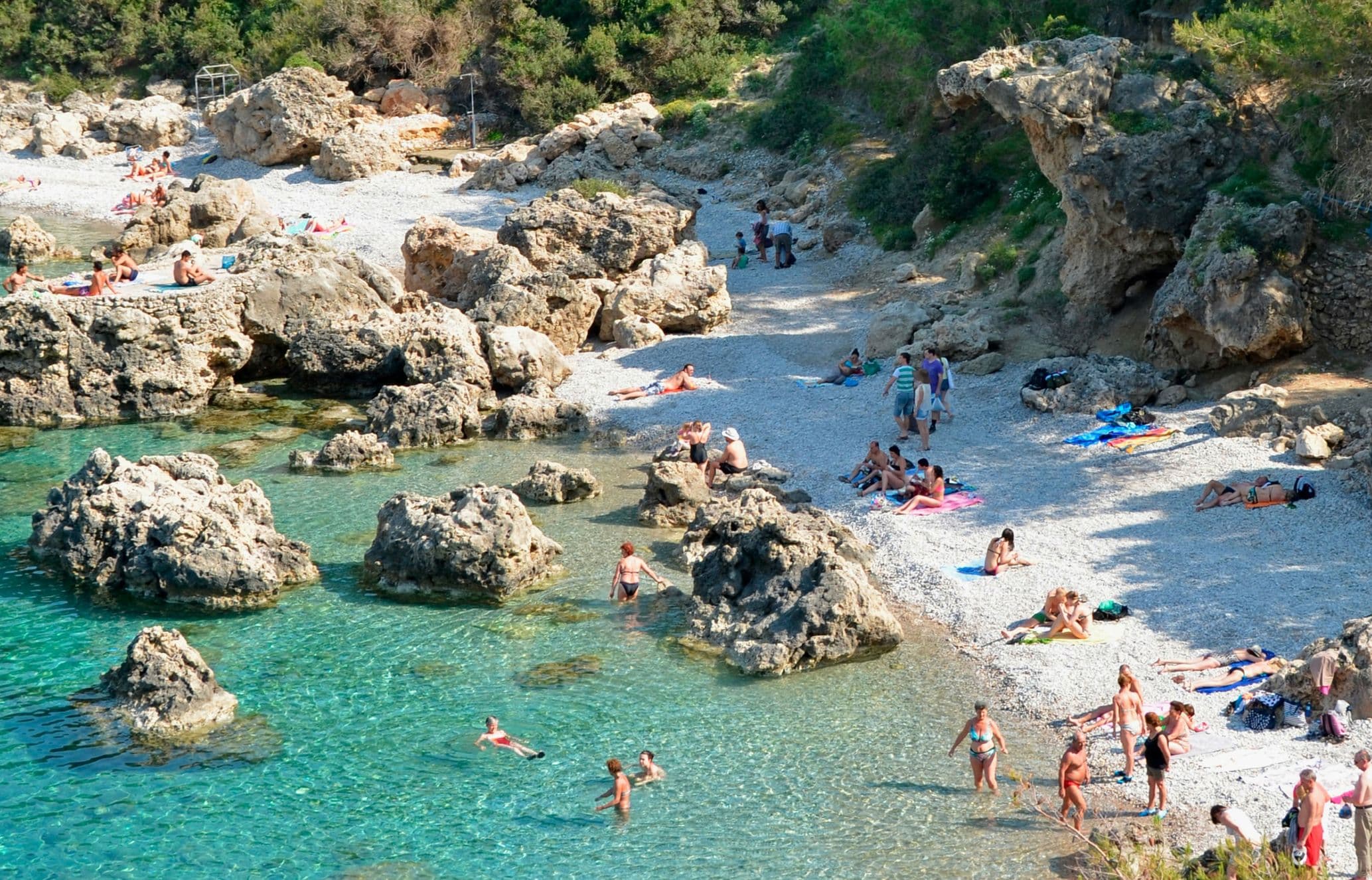 People swimming in sea at Anthony Quinn Bay, Rhodes