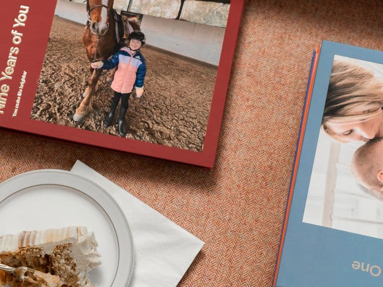 Birthday cake and collection of hardcover photo books
