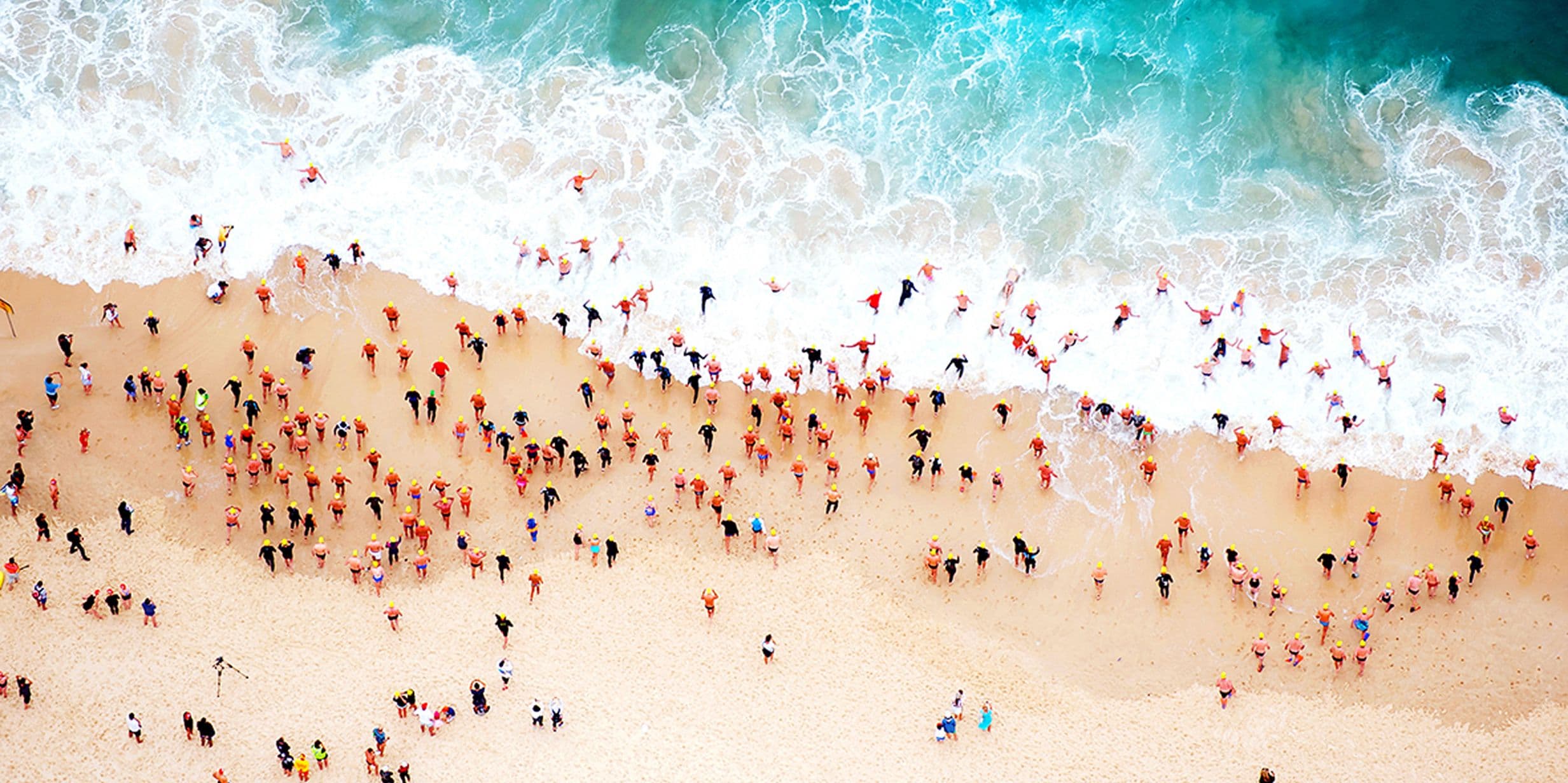 Swimmers run into the water at Bondi Beach, Australia