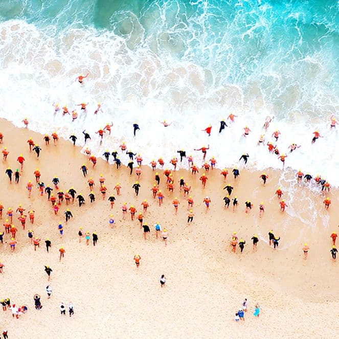 Swimmers run into the water at Bondi Beach, Australia