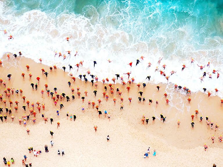 Swimmers run into the water at Bondi Beach, Australia