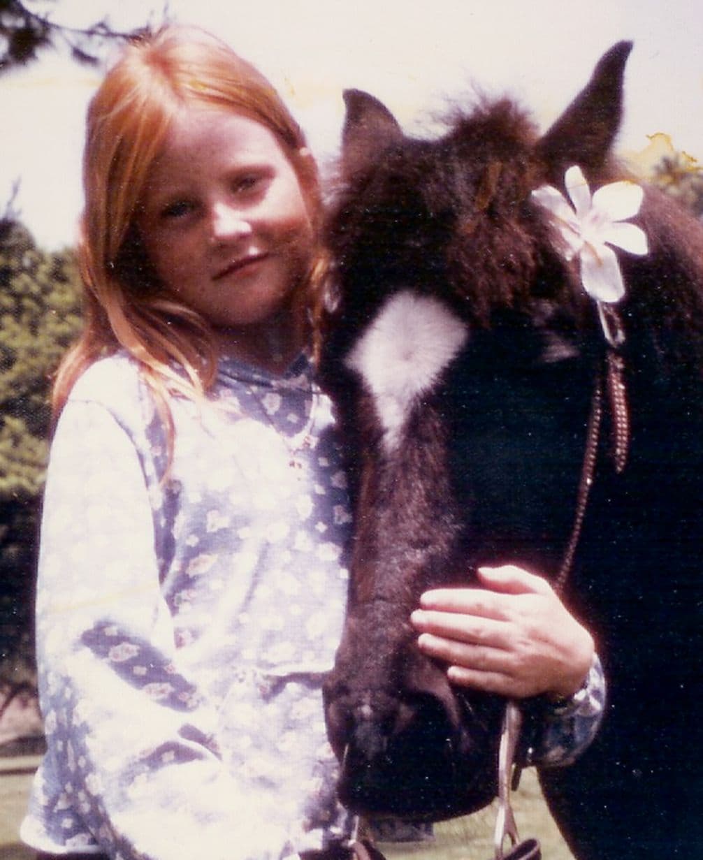 An 8-year-old Staci Layne Wilson hugging her pony, Smokey