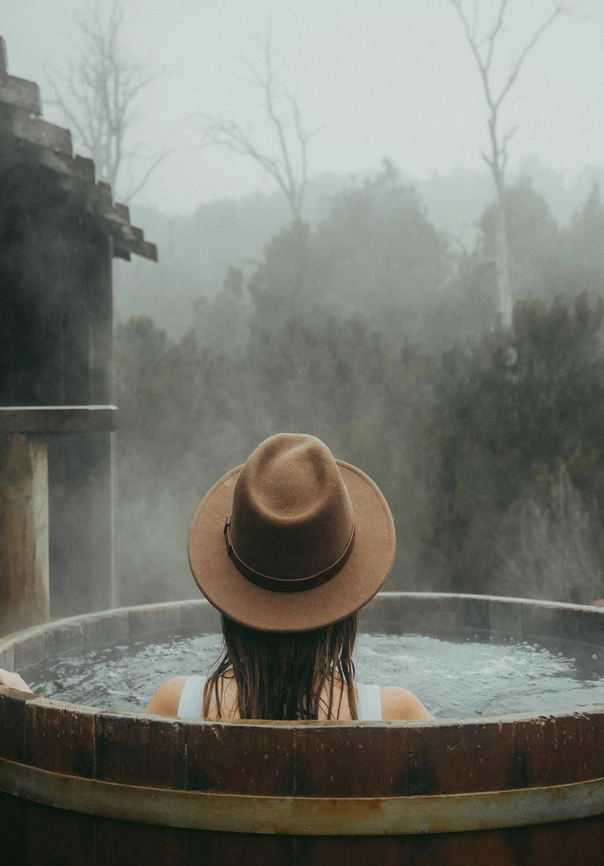 A woman in hot tub with steam rising from the chill of the air