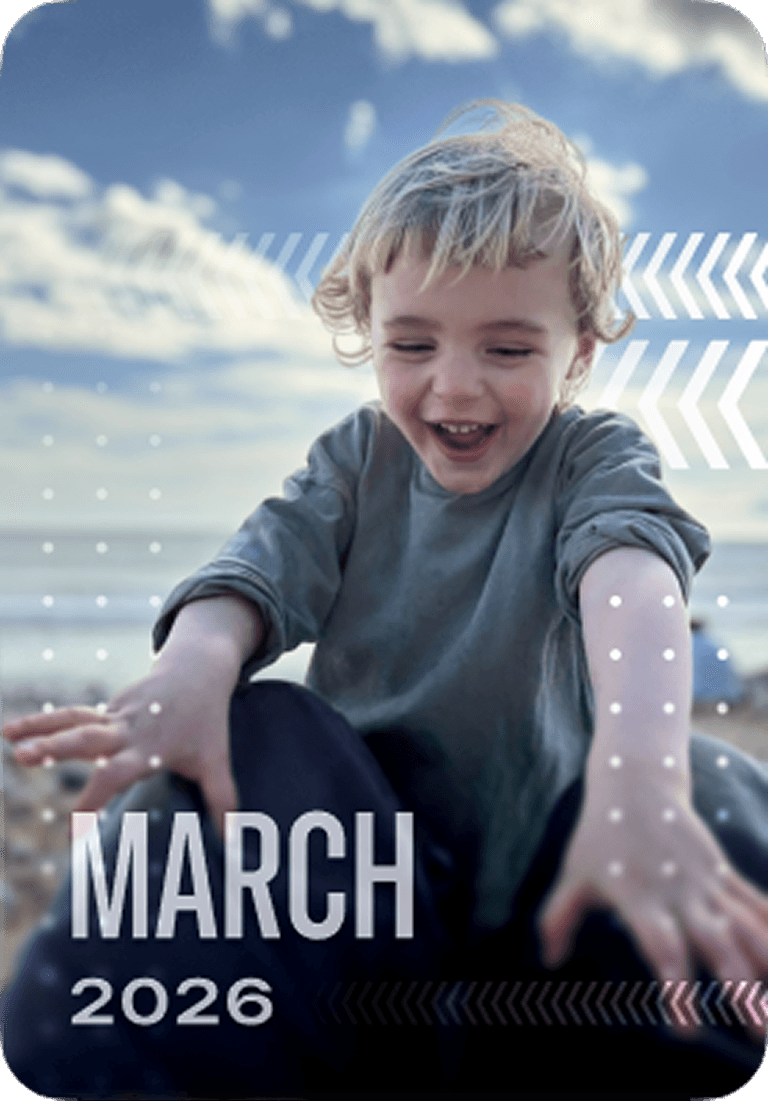 A smiling child with tousled hair reaches forward, playing outdoors on a cloudy day. Text reads "March 2026."