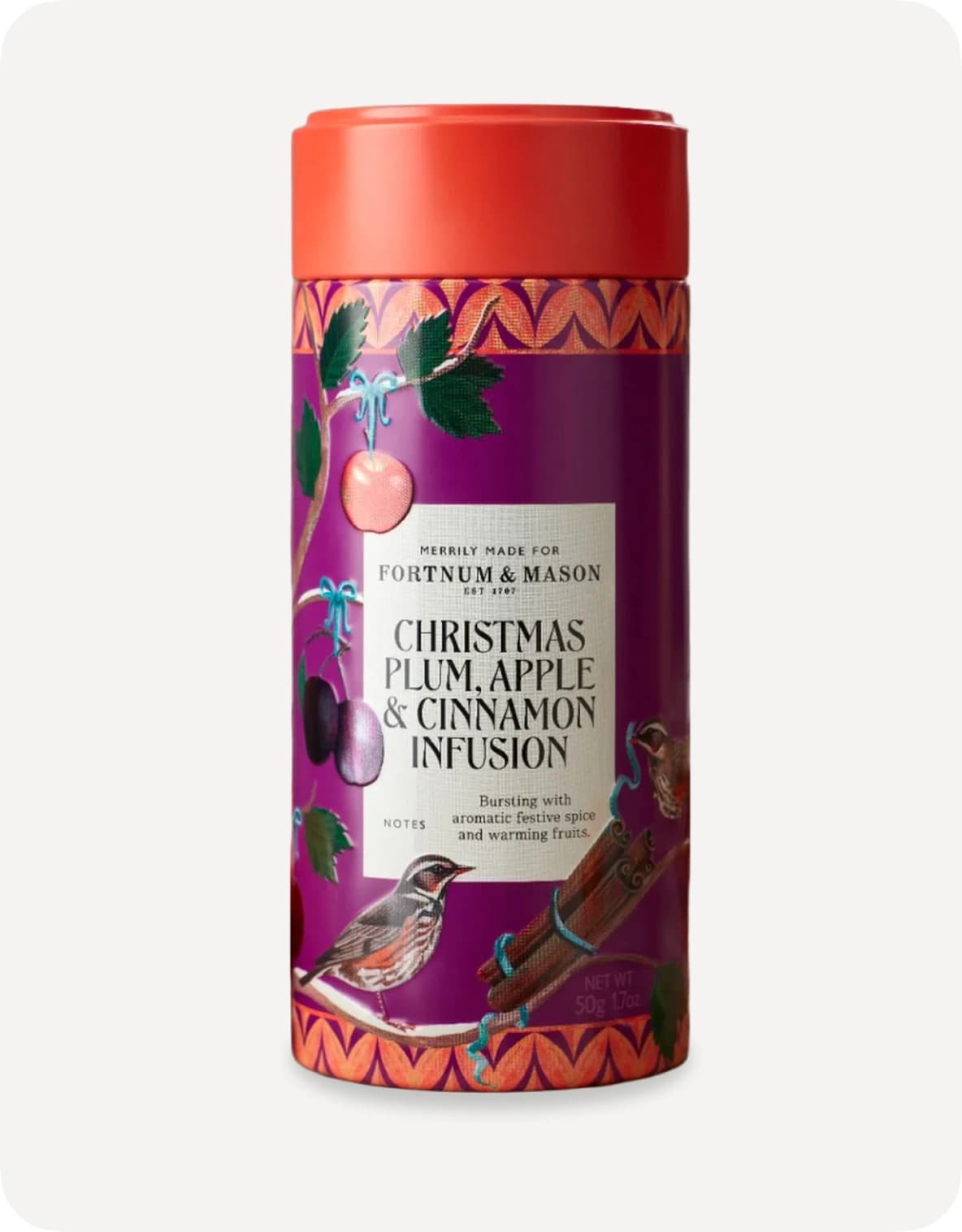 A festive tea tin labeled "Christmas Plum, Apple & Cinnamon Infusion" with colorful fruit and bird illustrations on a white background.