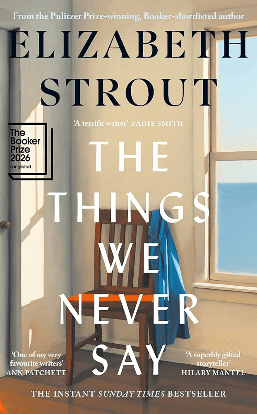 Book cover of "The Things We Never Say" by Elizabeth Strout, featuring a chair by a window with ocean view, acclaimed reviews, and literary award nominations.