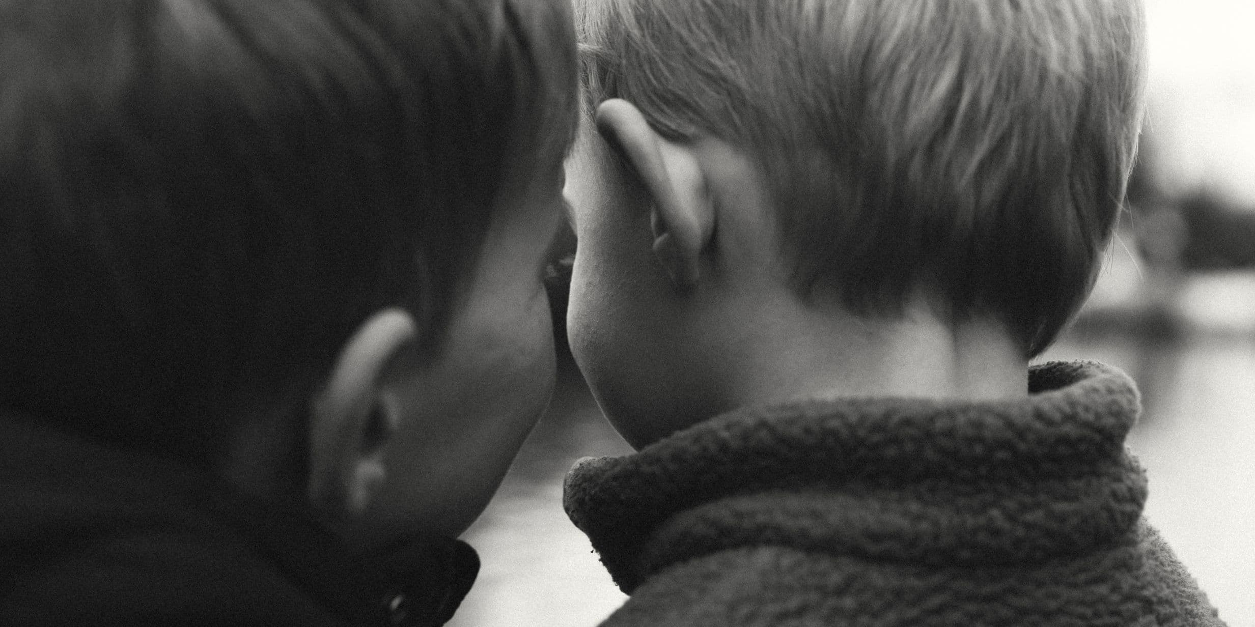 black and white photo of children's heads from the back