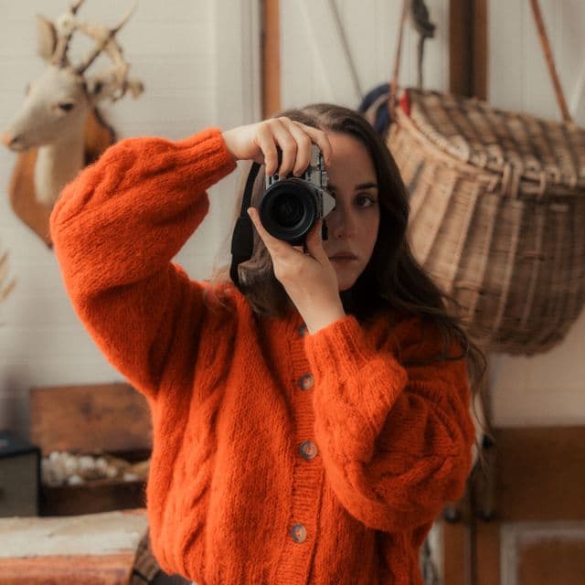 Emilie Hill portrait with camera covering eye