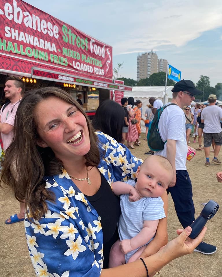 Woman holding baby a a festival