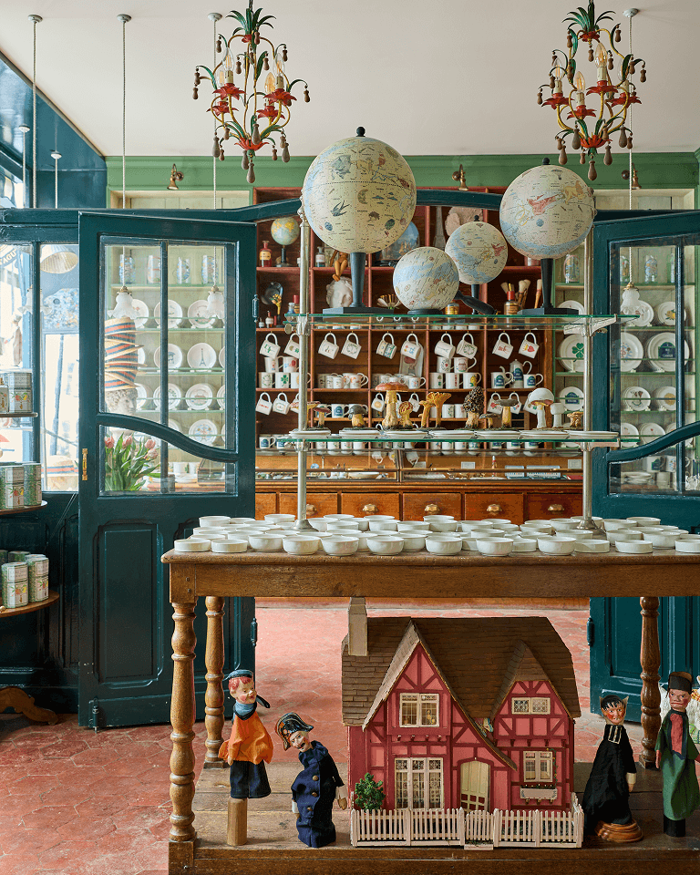 Globes suspended over a table of ceramics at Marin Montagut